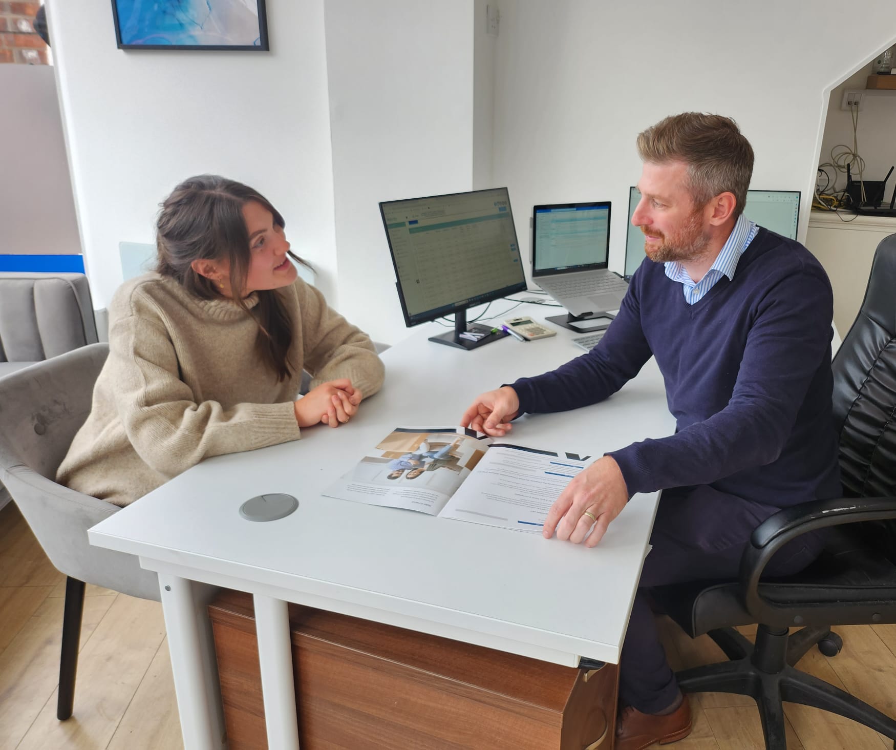 Mortgage adviser meeting with a first-time buyer at The Mortgage Cube's Devon office